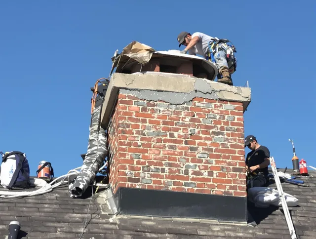 Lynnfield Chimney Sweep installing a custom chimney crown in Lynnfield, MA