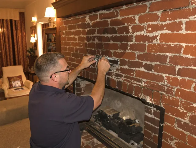 Lynnfield Chimney Sweep expert fixing a fireplace in Lynnfield, MA